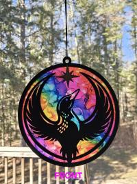 Front of Minnesota Rainbow Resistance Loon, Minnesota artist, suncatcher, translucent, northern lights. Made by Betsy Skagen of Blue Waters Studio & Emporium. Made in Minnesota.