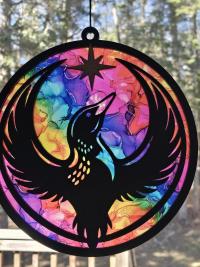 Minnesota Rainbow Resistance Loon, Minnesota artist, suncatcher, translucent, northern lights. Made by Betsy Skagen of Blue Waters Studio & Emporium. Made in Minnesota.