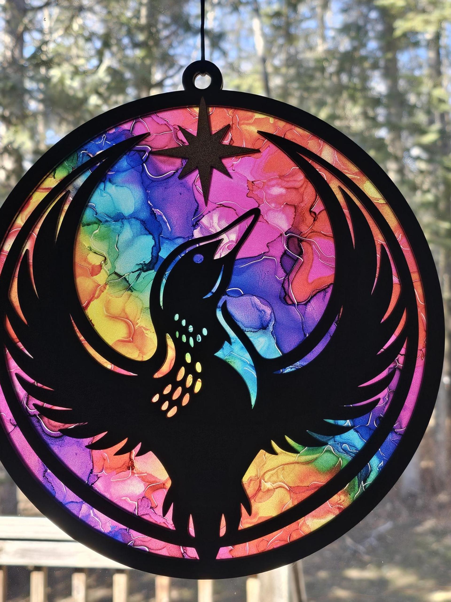 Minnesota Rainbow Resistance Loon, Minnesota artist, suncatcher, translucent, northern lights. Made by Betsy Skagen of Blue Waters Studio & Emporium. Made in Minnesota.