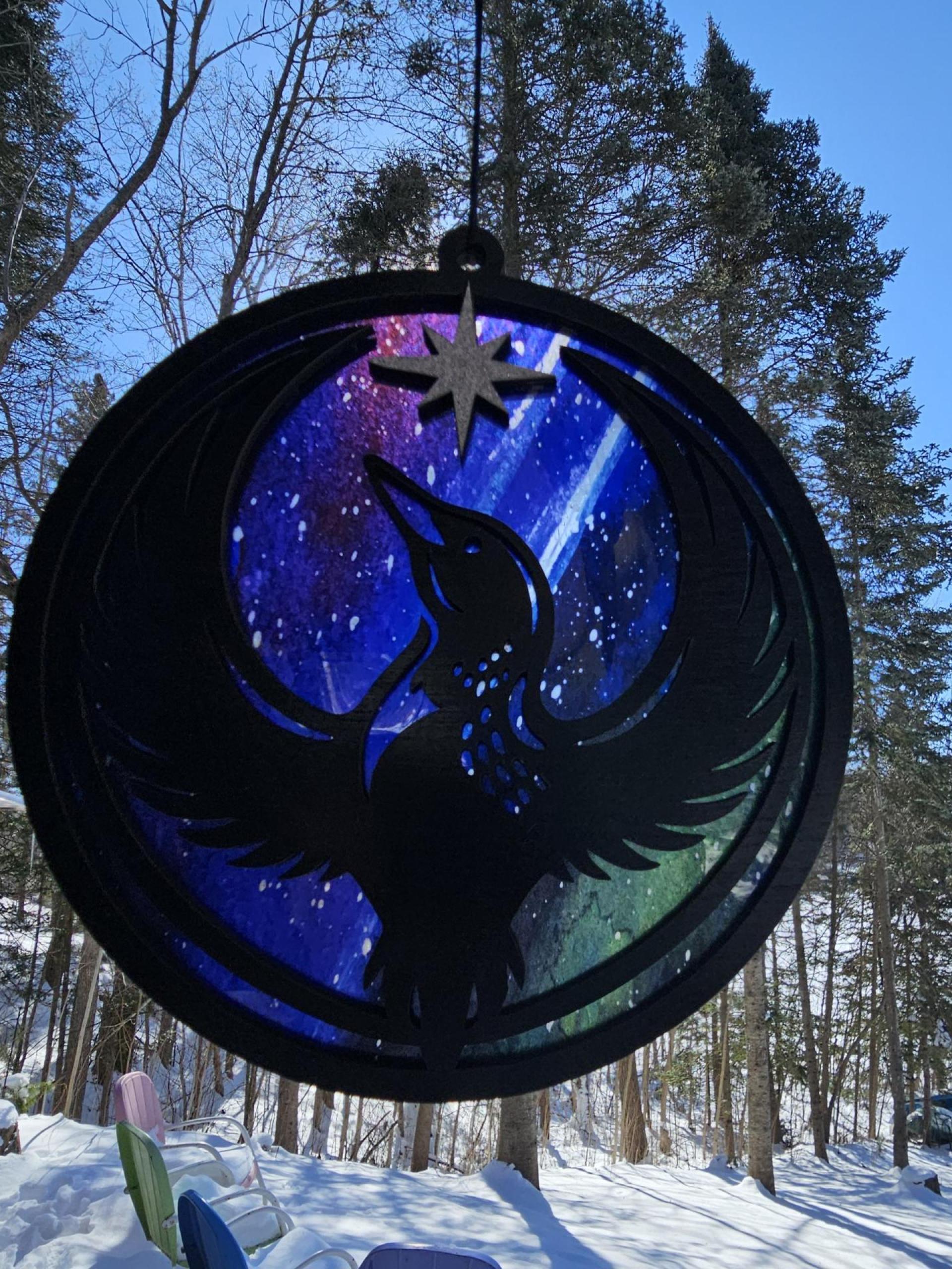 Back side of Minnesota Resistance Loon, Minnesota artist, suncatcher, translucent, northern lights. Made by Betsy Skagen of Blue Waters Studio & Emporium. Made in Minnesota.
